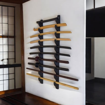 Set of wooden swords on a wall rack in a traditional Japanese room.