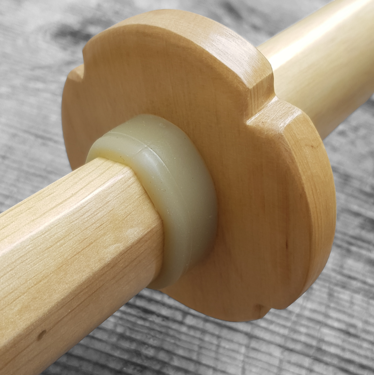 Wooden tsuba for bokken, displayed with a rubber stopper.