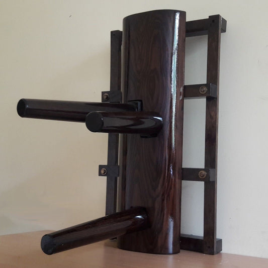 A compact Wing Chun wooden dummy with no legs, mounted on a stand, finished in ash brown.